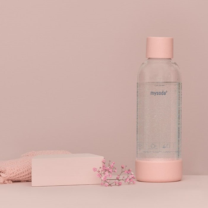 A pink Mysoda PET water bottle in matching pink studio setting