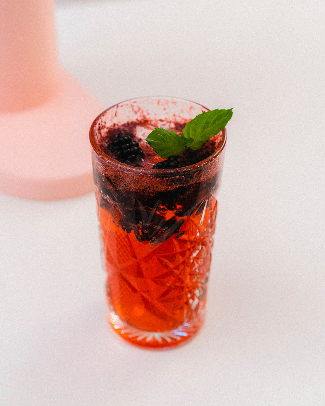 A glass of fruity blackberry grapefruit mocktail