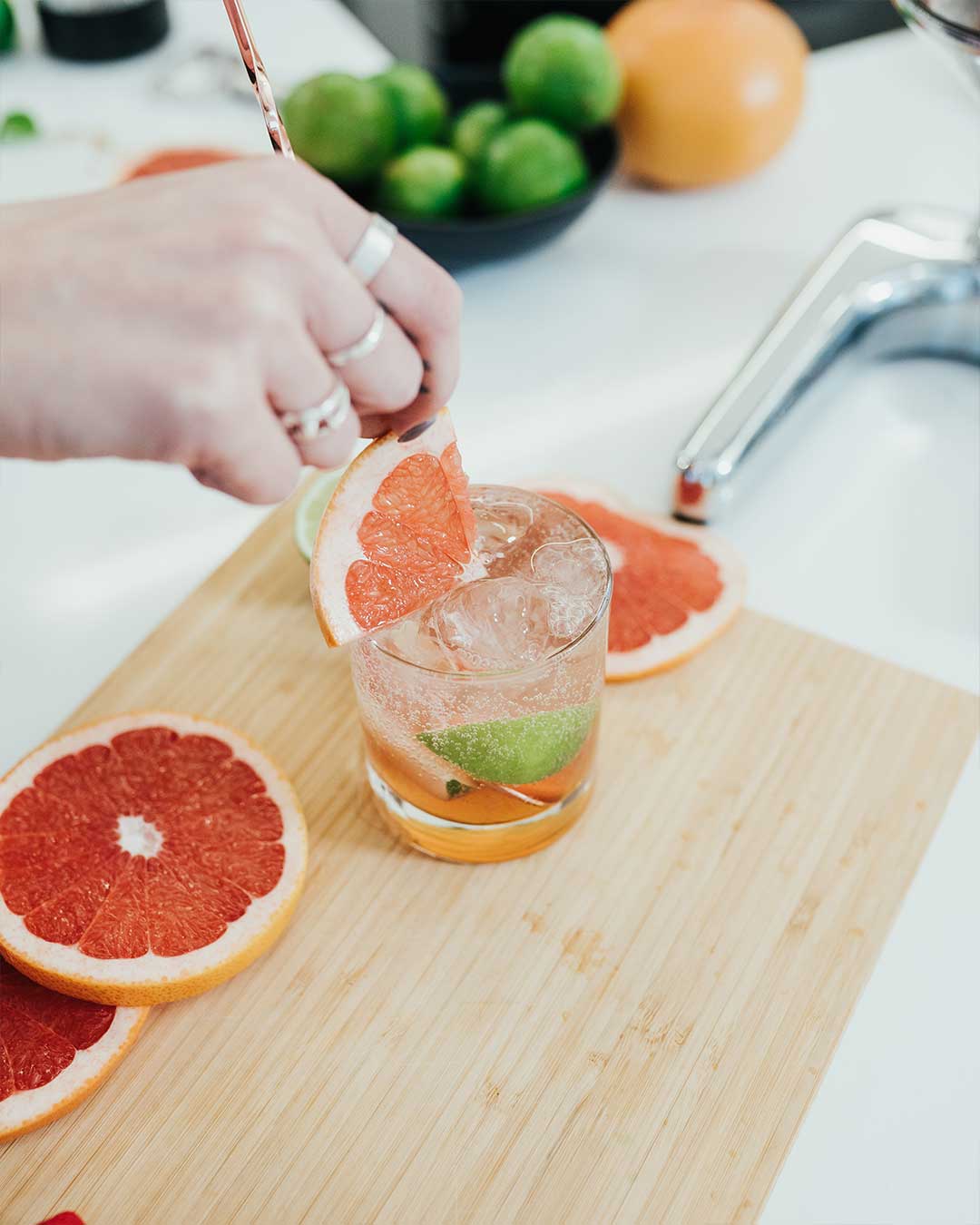 Adding the final touches to a glass of refreshing grapefruit drink