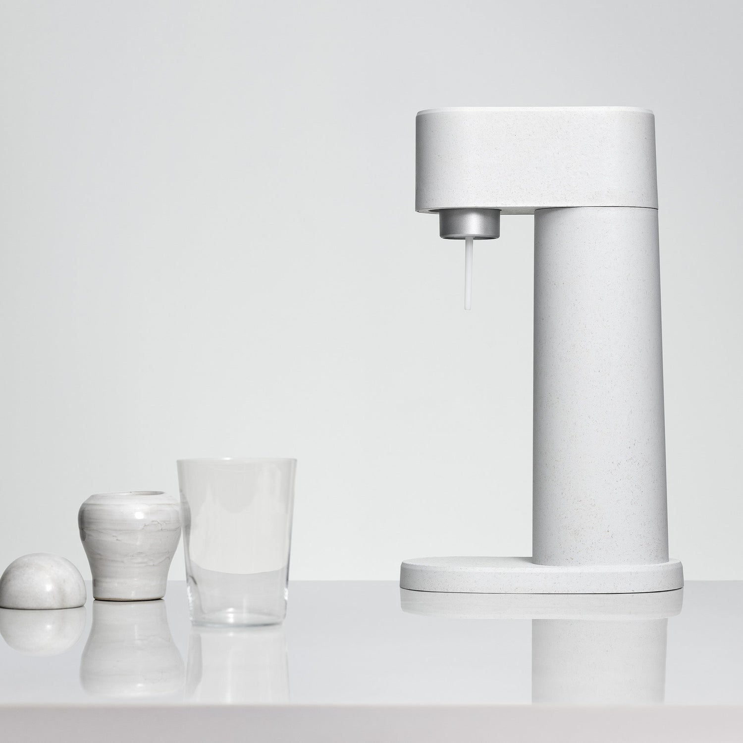 A white Woody sparkling water maker in front of a white backdrop
