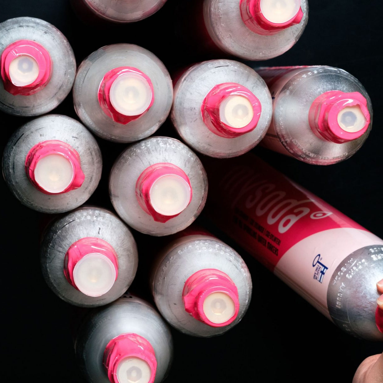 A bunch of Mysoda Co2 cylinders viewed top-down