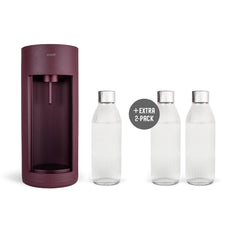 A beetroot-coloured Glassy sparkling water maker and three glass bottles