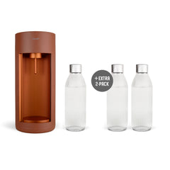 A terracotta-coloured Glassy sparkling water maker and three glass bottles