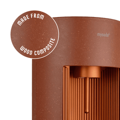 Glassy terracotta sparkling water maker with a close-up bubble showing the subtly visible wood fibres on the device's surface