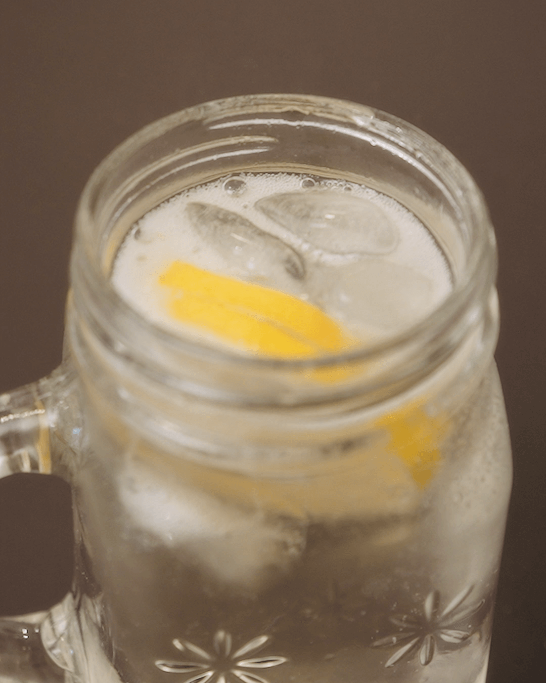 Colseup of a glass of cold elderflower mocktail drink