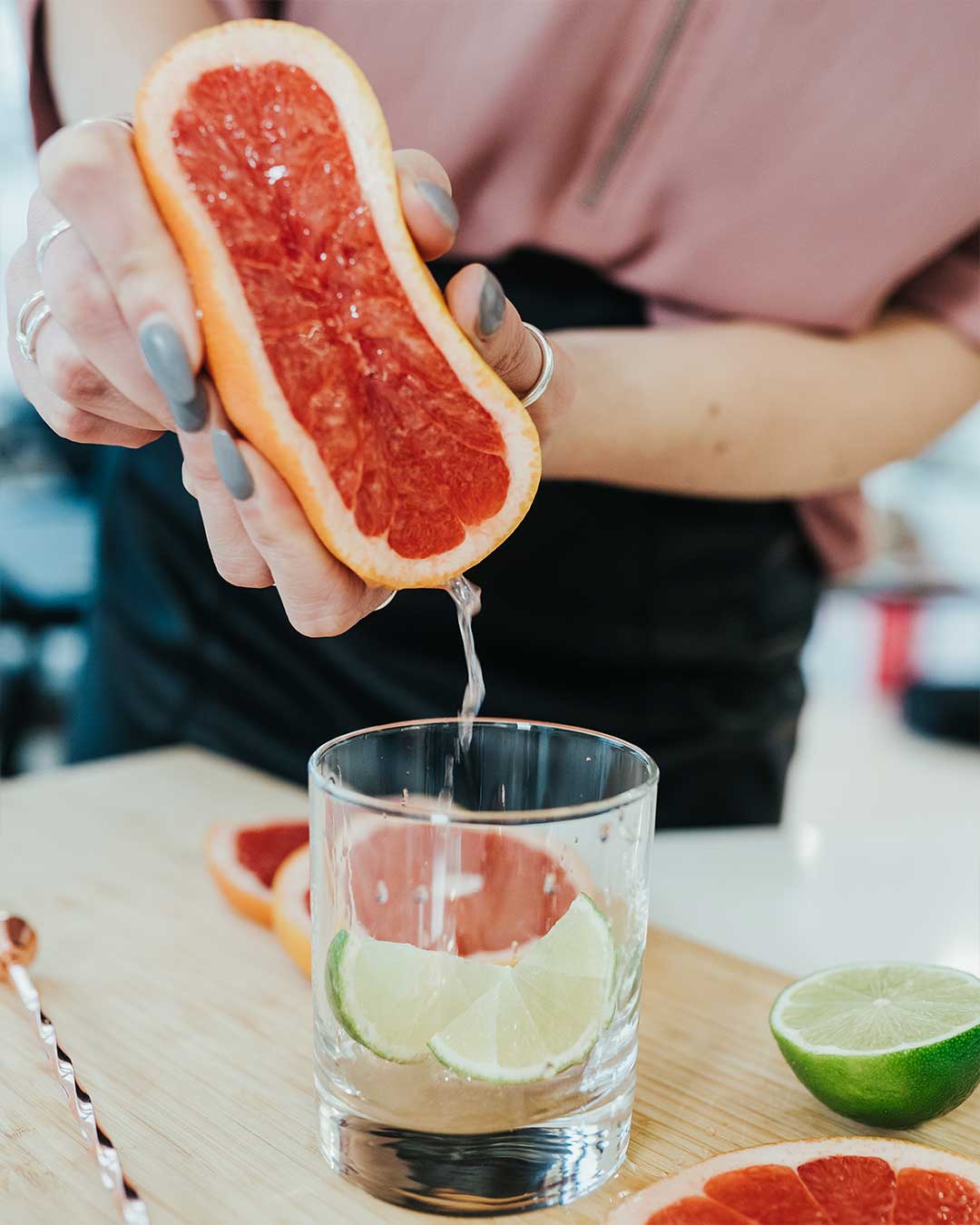 Grapefruit being squeezed into a glass