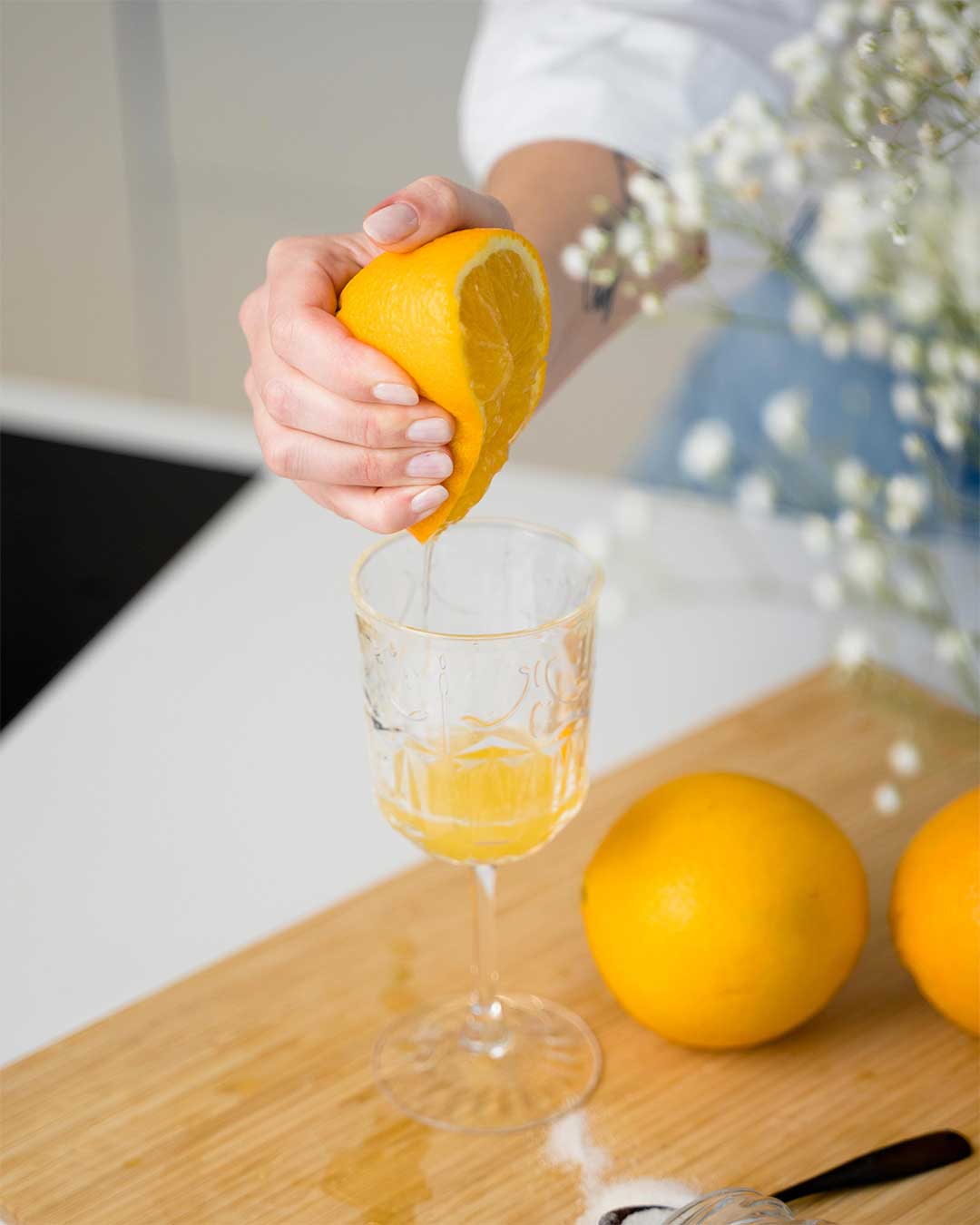 Orange being squeezed into a glass