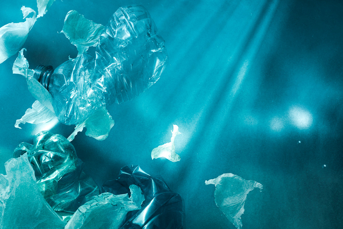 Pieces of plastic waste floating underwater